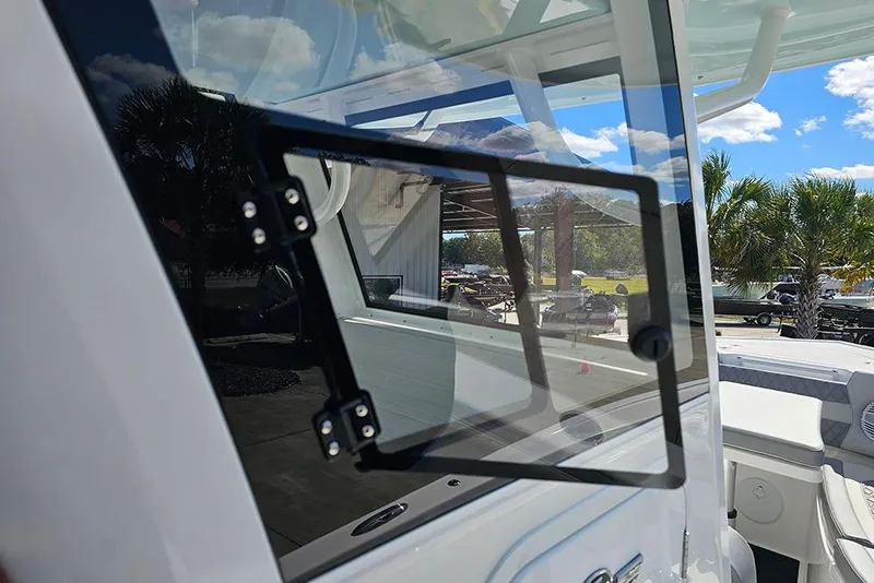 Slide: The Image of 2026 Sea Pro 322 Offshore boat window detail with outdoor reflection. - 33