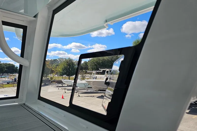 Slide: The Image of View from 2026 Sea Pro 322 Offshore boat window, showcasing marina and blue sky. - 34