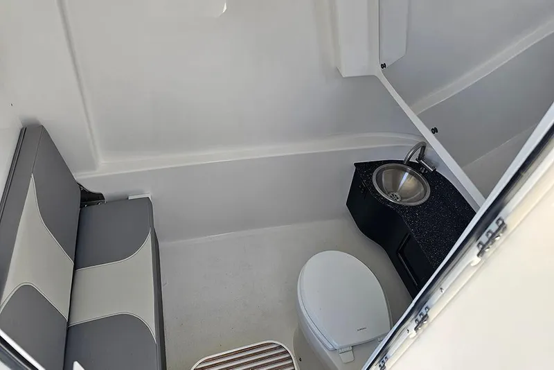Slide: The Image of Interior of 2026 Sea Pro 322 Offshore boat with toilet, sink, and seating area. - 36