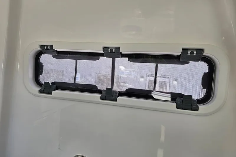 Slide: The Image of 2026 Sea Pro 322 Offshore boat window with secure latches and mesh screen. - 40