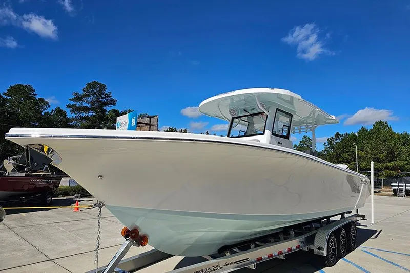 Slide: The Image of 2026 Sea Pro 322 Offshore boat on trailer under clear blue sky. - 5