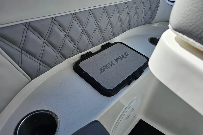 Slide: The Image of 2026 Sea Pro 322 Offshore boat interior with quilted upholstery and branded storage compartment. - 50