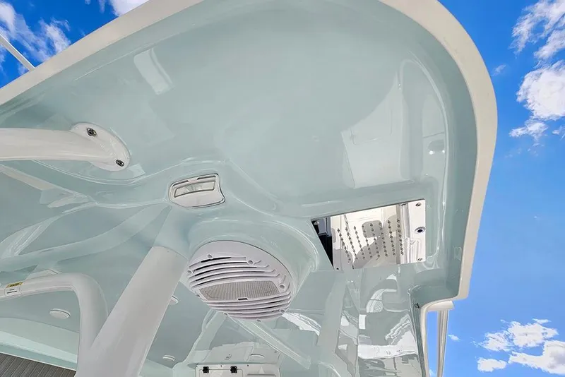 Slide: The Image of 2026 Sea Pro 322 Offshore boat ceiling with speaker, under a clear blue sky. - 59