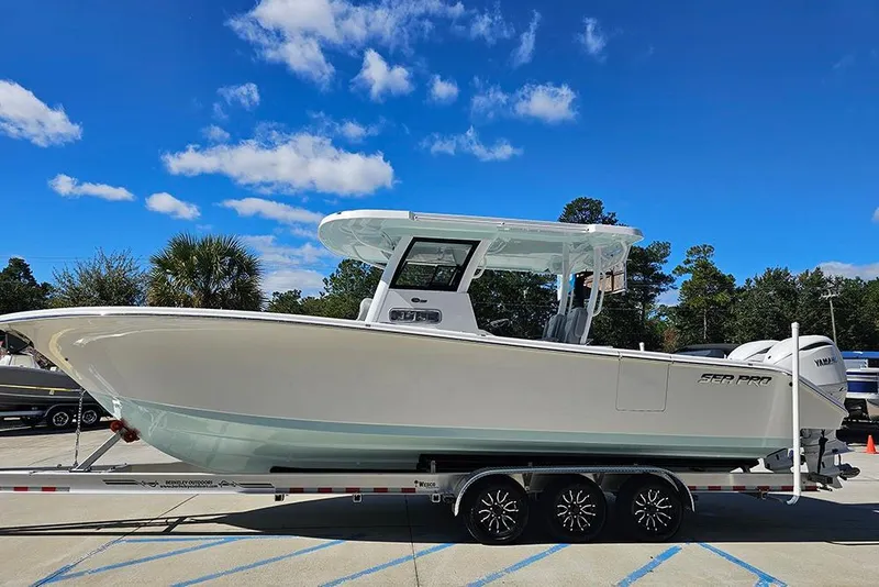 Slide: The Image of 2026 Sea Pro 322 Offshore boat on trailer under clear blue sky. - 6