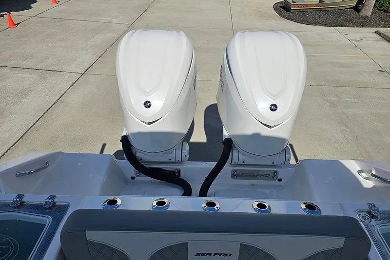 Slide: The Image of 2026 Sea Pro 322 Offshore boat with dual outboard engines, docked on concrete. - 60