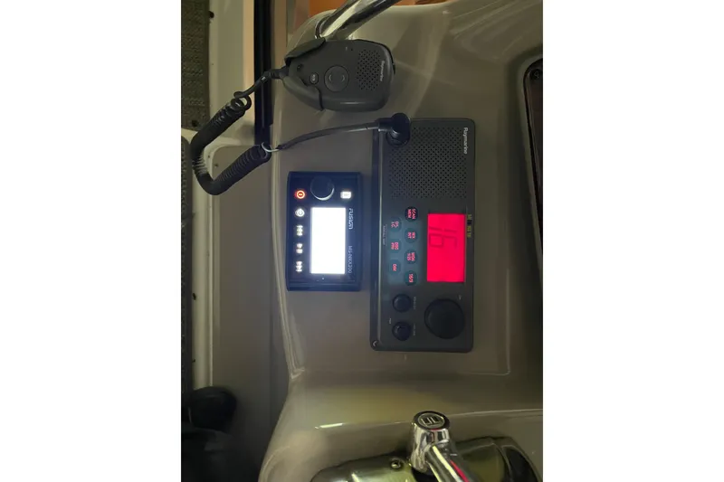 Slide: The Image of Control panel of a 2003 Sea Ray 340 Sundancer boat with radio and microphone. - 13