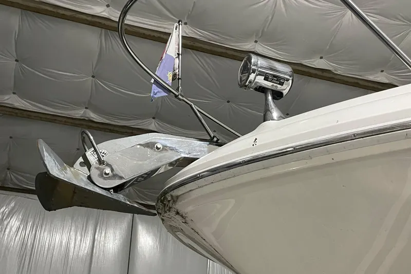 Slide: The Image of 2003 Sea Ray 340 Sundancer bow with anchor and spotlight in a covered storage. - 27
