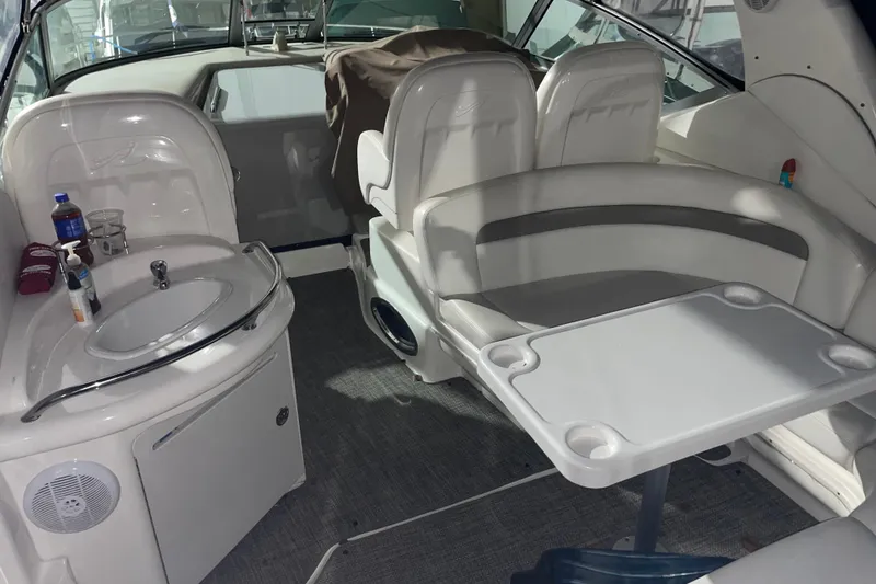 Slide: The Image of 2003 Sea Ray 340 Sundancer interior with seating, table, and sink. - 3