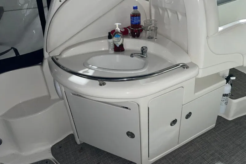 Slide: The Image of 2003 Sea Ray 340 Sundancer boat sink area with faucet and storage cabinets. - 5