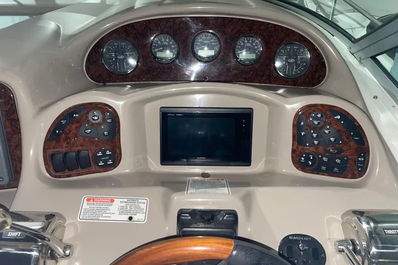 Slide: The Image of Dashboard of a 2003 Sea Ray 340 Sundancer boat with gauges and controls. - 7