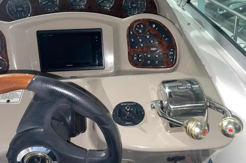 Slide: The Image of 2003 Sea Ray 340 Sundancer helm with Garmin display and throttle controls. - 9