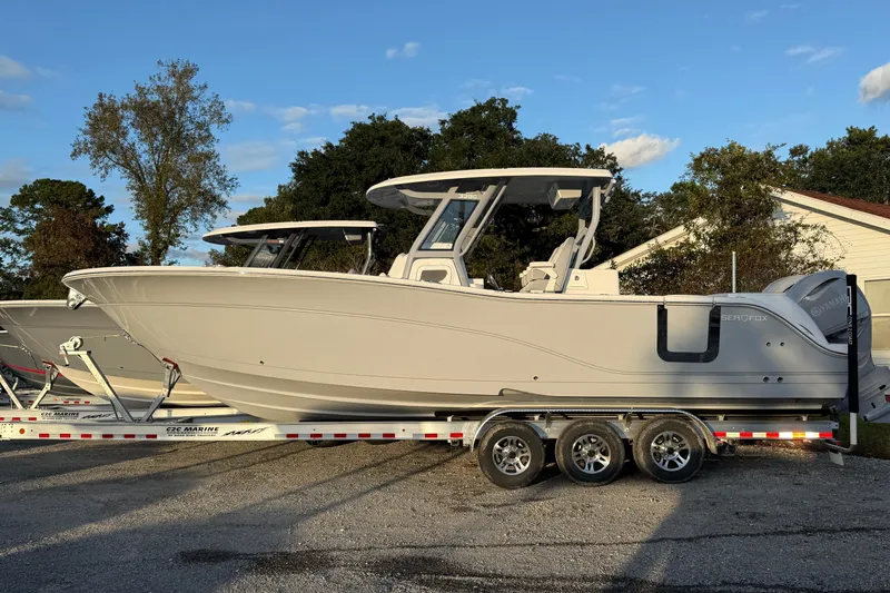 The Image of 2026 Sea Fox 328 Commander boat on trailer, parked outdoors. - 0