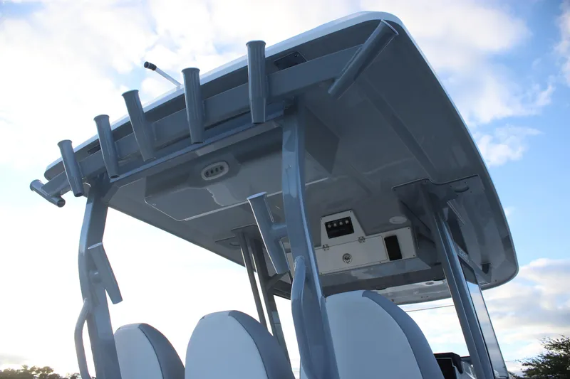 Slide: The Image of 2026 Sea Fox 328 Commander boat's helm station with rod holders and electronics. - 11