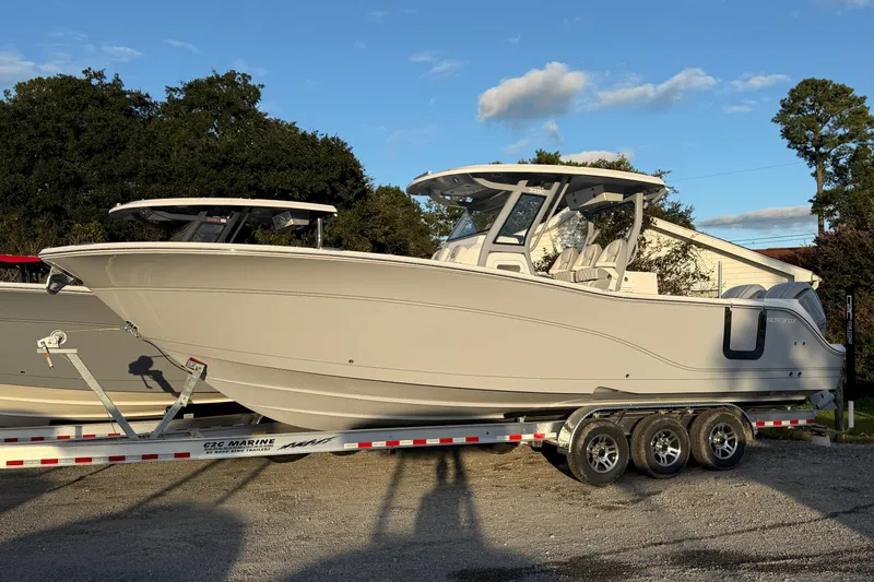 Slide: The Image of 2026 Sea Fox 328 Commander boat on trailer, parked outdoors under blue sky. - 2