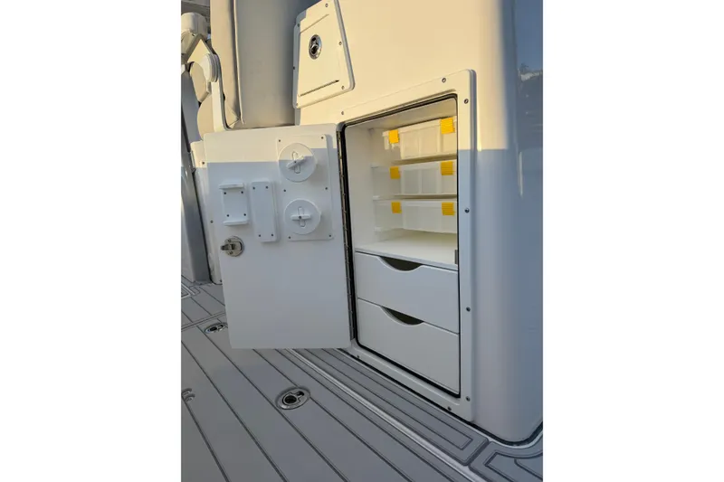 Slide: The Image of Storage compartment on a 2026 Sea Fox 328 Commander boat, featuring organized shelves and drawers. - 20