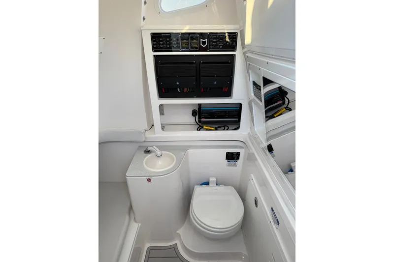 Slide: The Image of Interior of 2026 Sea Fox 328 Commander boat featuring a compact bathroom setup. - 21
