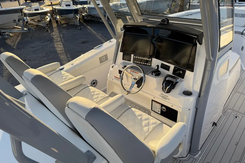 Slide: The Image of 2026 Sea Fox 328 Commander boat cockpit with dual seats and advanced navigation controls. - 23