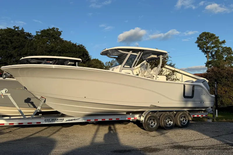 Slide: The Image of 2026 Sea Fox 328 Commander boat on trailer, parked outdoors under clear sky. - 3