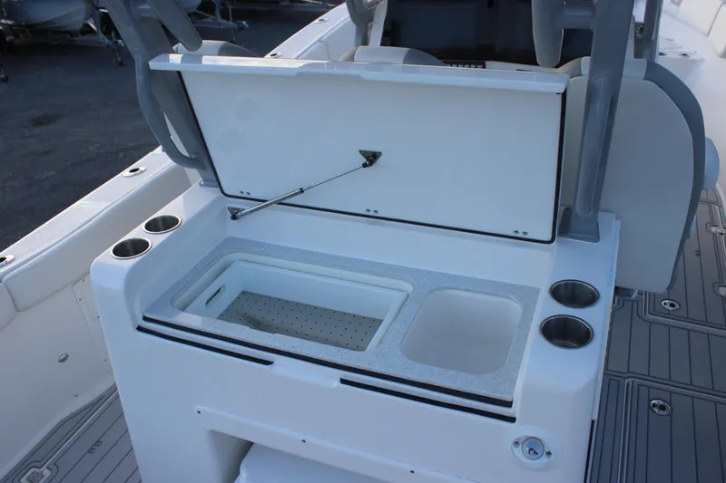 Slide: The Image of 2026 Sea Fox 328 Commander boat with open storage compartment and cup holders. - 8