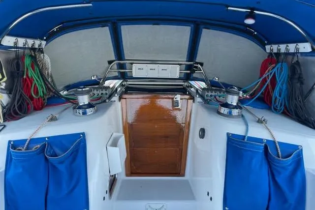 Slide: The Image of 2004 Sabre 426 yacht cockpit with steering wheel, navigation equipment, and marina view. - 15
