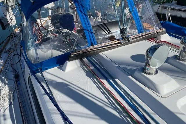 Slide: The Image of Steering wheel of a 2003 Sabre 426 sailboat, featuring navigation equipment. - 16