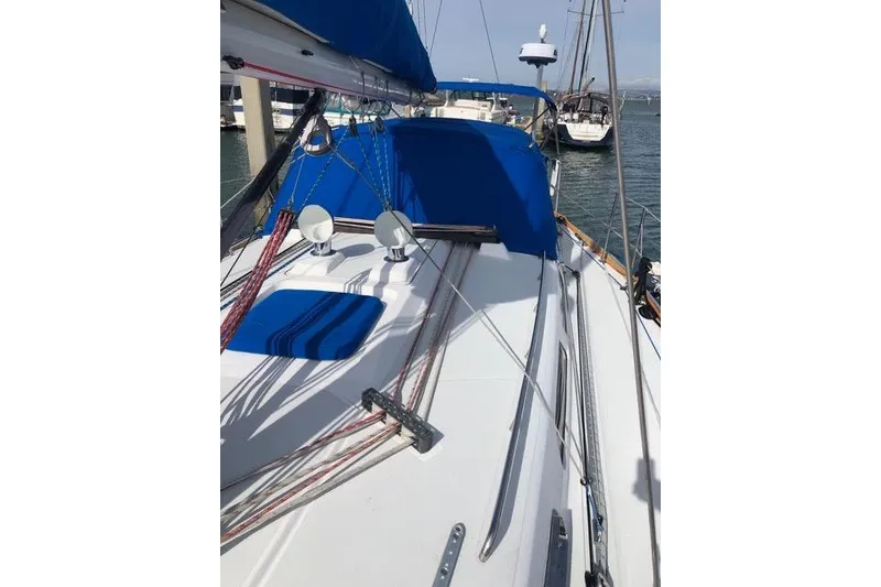Slide: The Image of 2003 Sabre 426 sailboat deck with blue canopy and colorful rigging lines. - 18