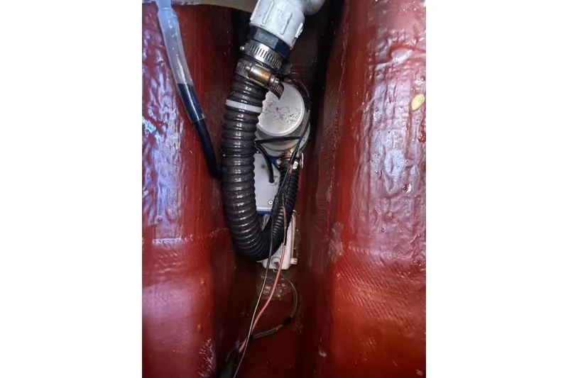 Slide: The Image of Compact bathroom in 2003 Sabre 426 yacht with sink, toilet, and storage cabinet. - 34