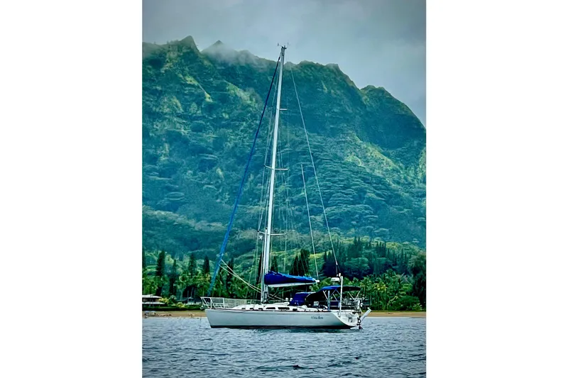 Slide: The Image of 2004 Sabre 426 sailboat docked in marina with blue covers. - 5