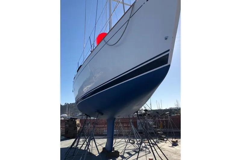 Slide: The Image of 2004 Sabre 426 sailboat with sleek design and full sails. - 9