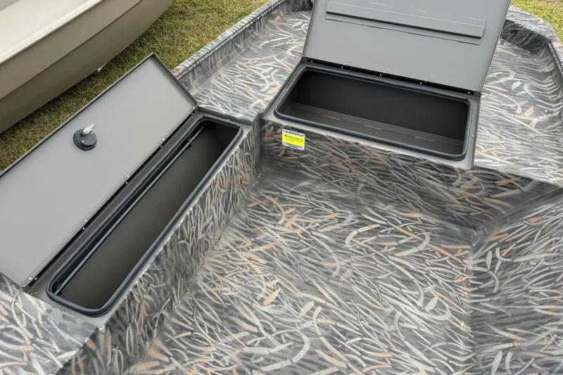 Slide: The Image of 2026 Alweld 1652 Invader boat interior with camo pattern, docked at sunset. - 10