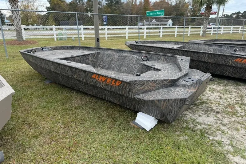 Slide: The Image of 2026 Alweld 1652 VV Invader boat with camouflage design on grass. - 12
