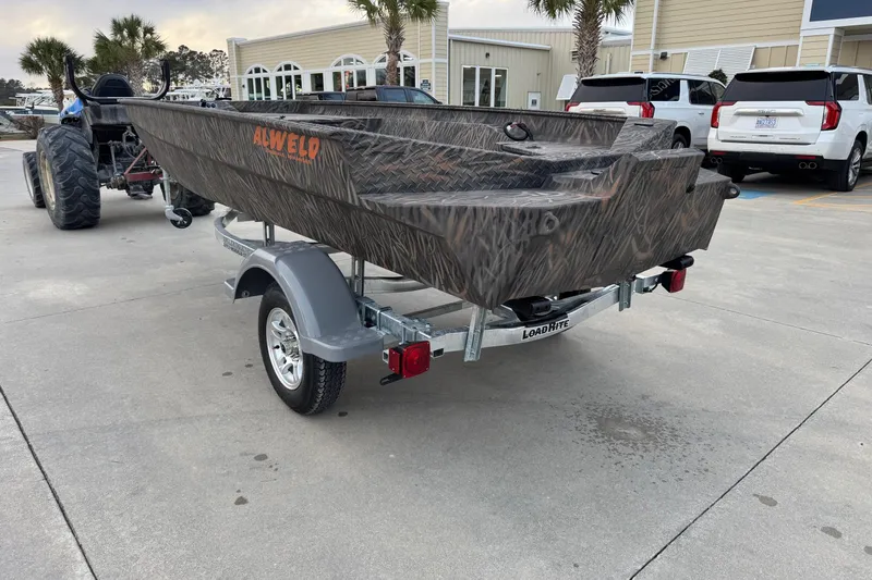 Slide: The Image of 2026 Alweld 1652 VV Invader boat on trailer, parked outdoors. - 4