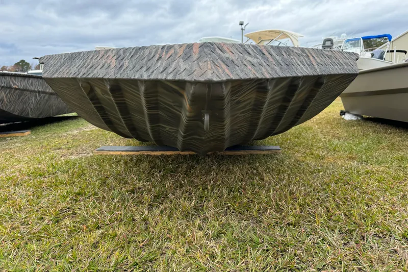 Slide: The Image of 2026 Alweld 1652 VV Invader boat hull on grass, showcasing its rugged design. - 6