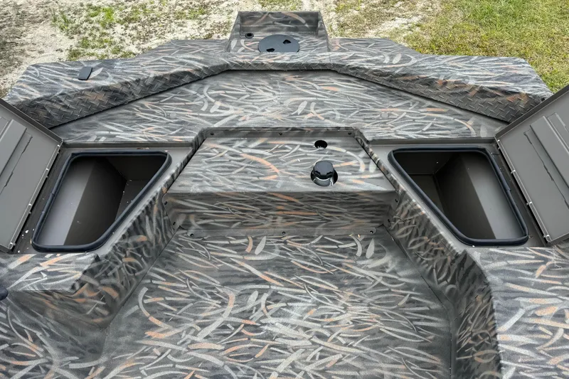 Slide: The Image of 2026 Alweld 1652 VV Invader boat interior with camo pattern and open storage compartments. - 9