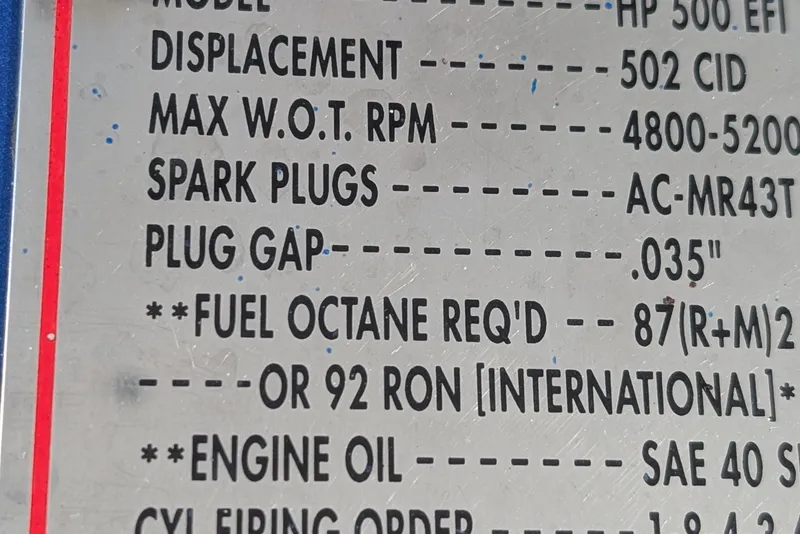 Slide: The Image of Close-up of Advantage Poker Run 40 engine specifications plate, detailing spark plug and fuel requirements. - 13