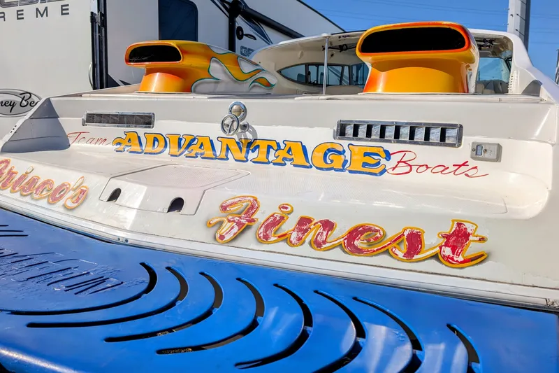 Slide: The Image of Rear view of 2000 Advantage Poker Run 40 boat with vibrant graphics. - 18