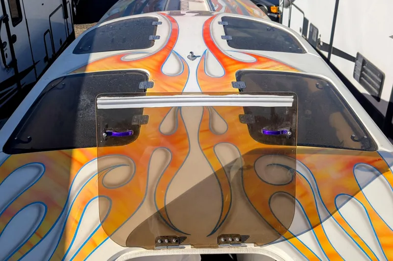 Slide: The Image of 2000 Advantage Poker Run 40 boat with vibrant flame graphics on deck. - 2