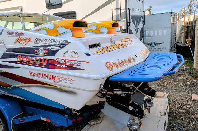 Slide: The Image of 2000 Advantage Poker Run 40 boat with vibrant decals and blue swim platform. - 20
