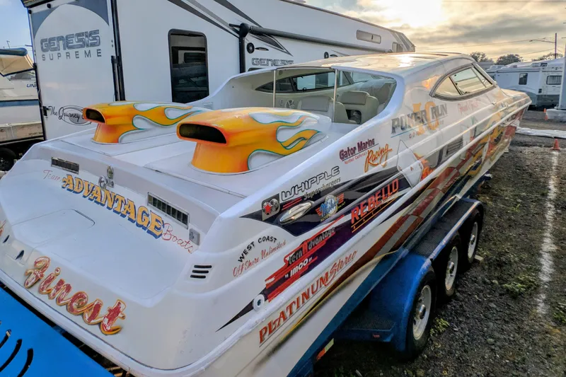 Slide: The Image of 2000 Advantage Poker Run 40 speedboat with vibrant decals on a trailer. - 23