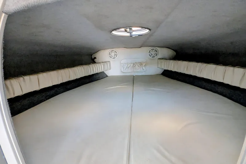 Slide: The Image of Interior cabin of 2000 Advantage Poker Run 40 boat, featuring cushioned seating and speakers. - 27