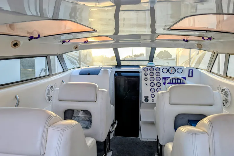 Slide: The Image of Interior of 2000 Advantage Poker Run 40 boat with white seating and control panel. - 3