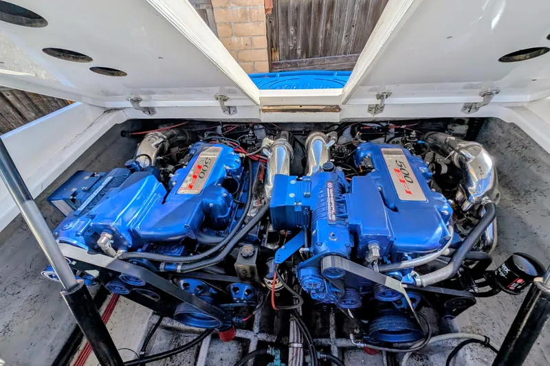 Slide: The Image of Twin blue engines in a 2000 Advantage Poker Run 40 boat, showcasing power and performance. - 5