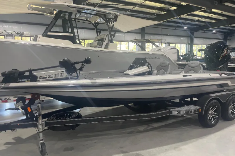 Slide: The Image of 2022 Skeeter ZX200 boat displayed indoors on a trailer. - 0