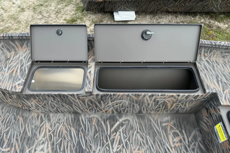 Slide: The Image of 2026 Alweld 1756 Invader boat interior with open storage compartment and control panel. - 9