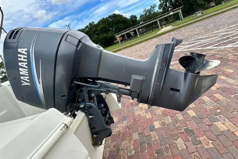 Slide: The Image of Yamaha outboard motor on 2004 Bennington RL 210 boat, parked on brick pavement. - 14