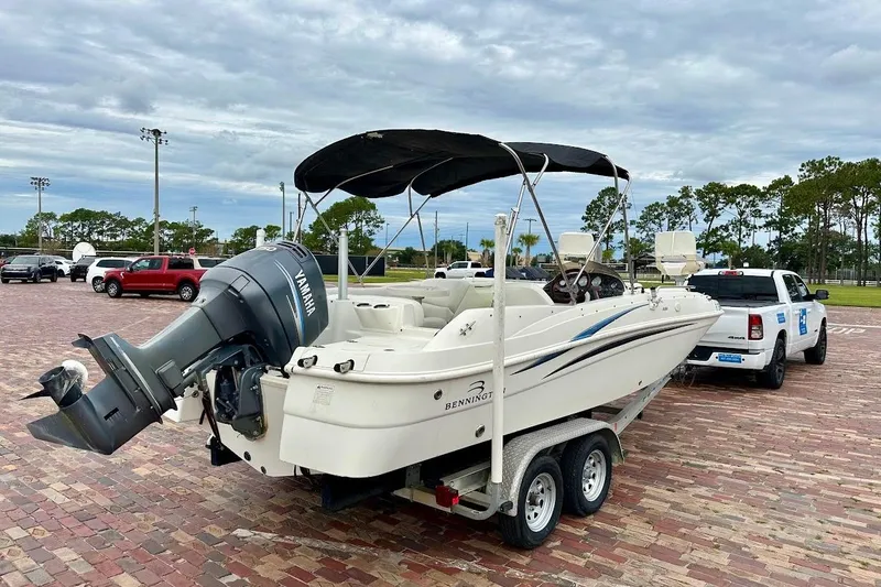 Slide: The Image of 2004 Bennington RL 210 boat on trailer, attached to a white pickup truck. - 7