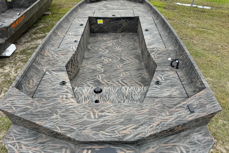 Slide: The Image of 2026 Alweld 1756 Invader boat on trailer, parked outdoors near palm trees. - 5