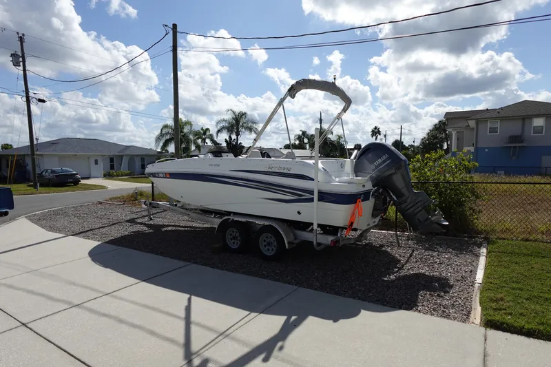 Slide: The Image of 2021 Hurricane Sundeck Sport 218 OB boat on trailer in residential driveway. - 11