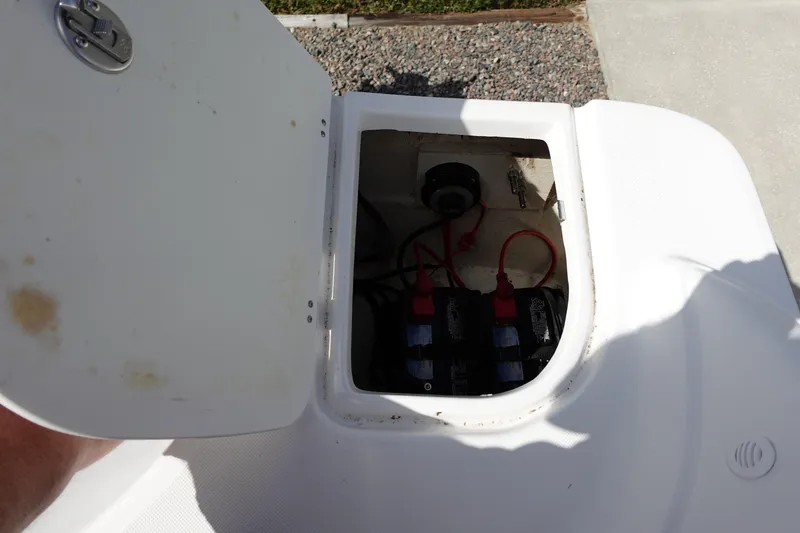 Slide: The Image of Open battery compartment of 2021 Hurricane Sundeck Sport 218 OB boat. - 17