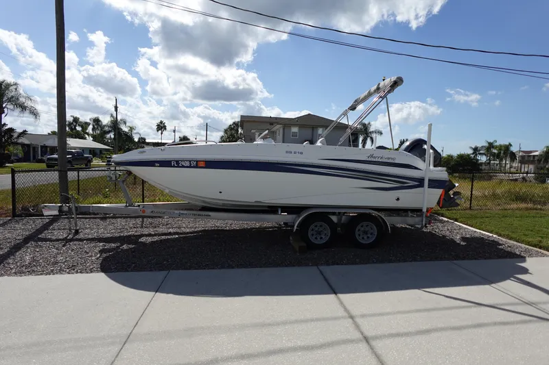 Slide: The Image of 2021 Hurricane Sundeck Sport 218 OB boat on trailer, parked outdoors. - 2
